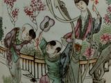 a vase with a picture of a woman and children on it