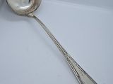 a silver spoon with a spoon handle on a plate
