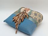 a blue pillow with a bunch of wooden sticks on it