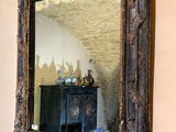 a mirror hanging on the wall above a cabinet