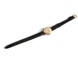 an image of a black watch with a gold face on a white background
