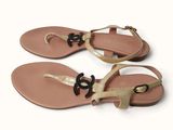 women ' s leather sandals with a gold strap and a black buckle