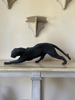 a statue of a cat that is on a table