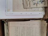 a box full of old letters and papers sitting on the floor