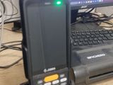 a cell phone sitting on top of a desk next to a computer