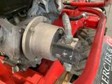 a close up of a motorcycle engine with a red frame