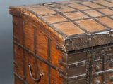 an old wooden chest with a metal latch on it