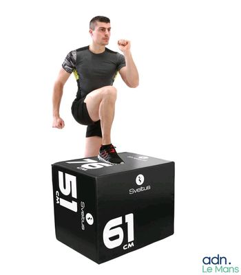 the man is standing on top of a box with his foot on it