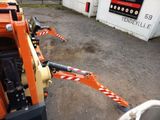 a small orange machine that is parked in a parking lot