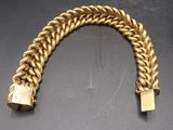 a close up of a gold bracelet with a lock on it