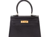 a black leather handbag on a white background