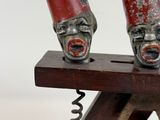 two wine openers that have faces on them