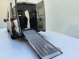 a white van with a ramp attached to the back of it