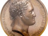 une vieille pièce de monnaie sur laquelle figure le portrait d'un homme, vu de profil