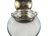 an image of a glass bowl with a metal lid on a white surface