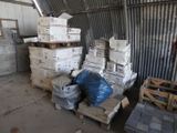a pile of boxes sitting on pallets in a warehouse