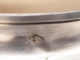 a close up of a silver plate with a hole in it