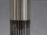 an image of a silver and black vase on a grey background