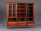 a wooden bookcase with two drawers and a glass door