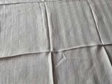 a bed with a white sheet on it and a pillow on top of it