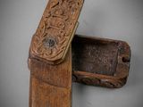 an old wooden box with carvings on it sitting on a table