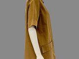 an image of a mannequin wearing a brown shirt and black leggings