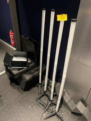 three baseball bats and a laptop on the floor