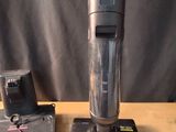 a vacuum that is sitting on a table next to a battery