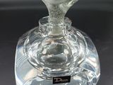 a glass vase with a heart on it sitting on a table