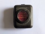 a small black box with a red light inside of it