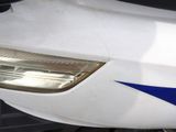 a close up of a blue and white train on the tracks