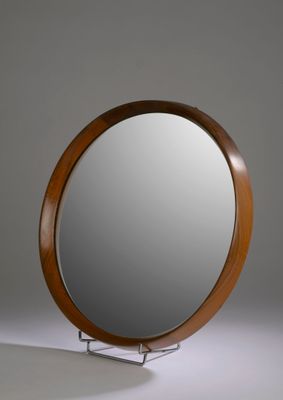 a mirror that is sitting on a stand in the room