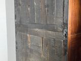 an old wooden cabinet in a room with tile flooring