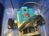 a blue box that has a drill and a cord in it