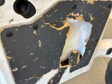 a hole in the door of a car that has been damaged