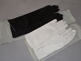 a pair of black and white gloves sitting on top of a table