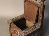 a small wooden chair with a mirror in it