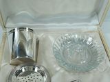 a silver cocktail shaker in a box with a spoon in it