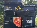 a vending machine that has a pizza on top of it