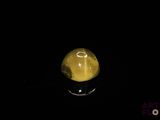 an image of a yellow stone in the dark