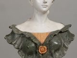 marble bust of a woman with a flower in her hair
