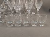 a lot of wine glasses and a pitcher on the table