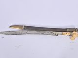 a knife that is laying on a table