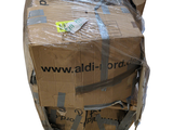 a large cardboard box wrapped in plastic and sitting on the floor