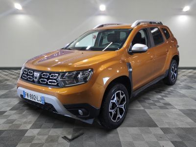 a picture of a bright orange pick up truck parked in a garage