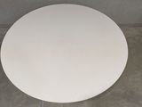 a white toilet seat sitting on the floor in a bathroom
