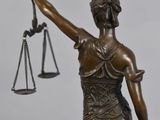 statue of lady justice holding the scales of the law