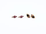 two pairs of gold and ruby earrings on a white background