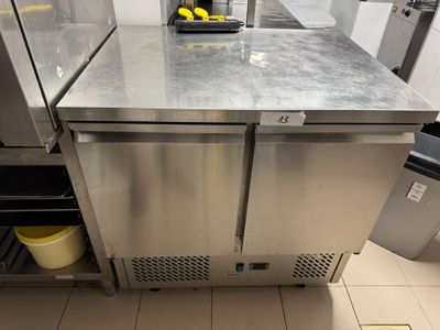stainless steel counter top in a commercial kitchen with a basket of lemons on the counter