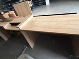 a desk with two drawers and a mirror in the corner